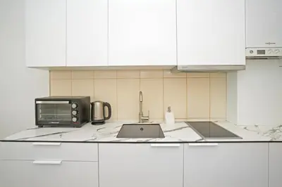 a kitchen counter with a microwave and a sink at Kaunas Castle Apartments - One bedroom flat in Kaunas