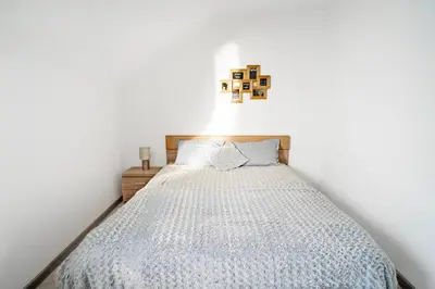 a bedroom with a bed in a white room at Kaunas Castle Apartments - 2 Bedroom Flat in Kaunas