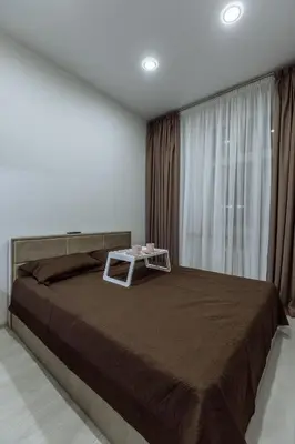 a bedroom with a large bed with a table on it at Švitrigailos 7 in Vilnius