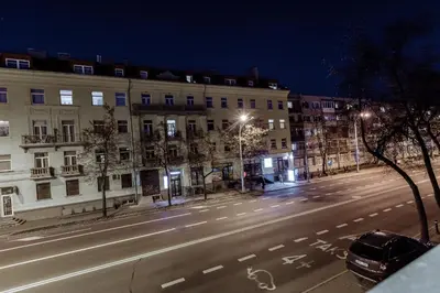 an empty city street at night with buildings at Švitrigailos 7 in Vilnius