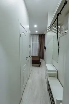 a white hallway with a white door and a room at Švitrigailos 7 in Vilnius