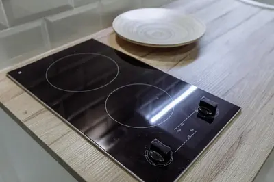 a stove top with a white plate on a table at Švitrigailos 7 in Vilnius