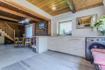 a kitchen with a washer and dryer in a house at Bedugnės pirtelė - Cosy Sauna House in Vilnius