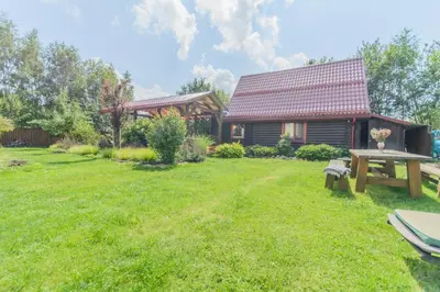 a house with a picnic table in the yard at Bedugnės pirtelė - Cosy Sauna House in Vilnius