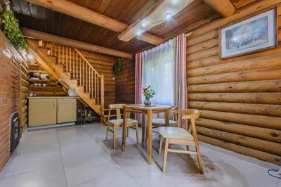 a dining room with a table and chairs and wooden walls at Bedugnės pirtelė - Cosy Sauna House in Vilnius