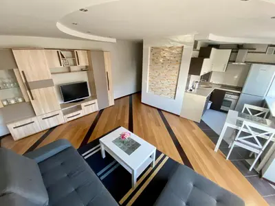 a living room with a couch and a table at Dange apartment in Šiauliai