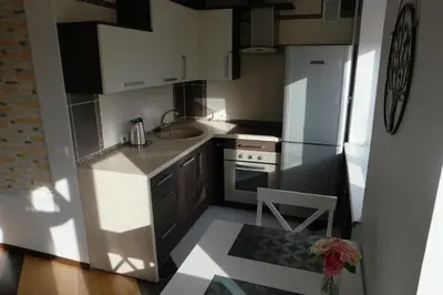 a small kitchen with a sink and a refrigerator at Dange apartment in Šiauliai