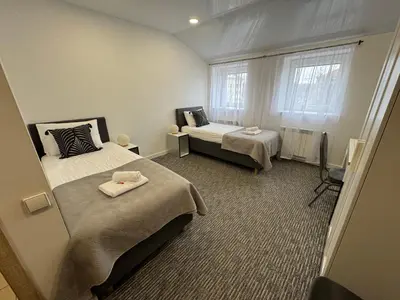 a small room with two beds and a window at Grey apartments 