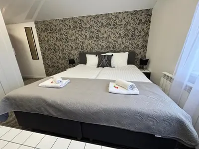 a bedroom with a bed with two towels on it at Grey apartments 
