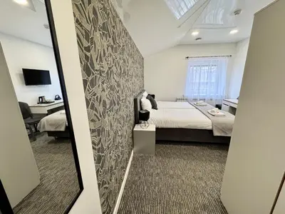 a bedroom with a large bed and a mirror at Grey apartments 