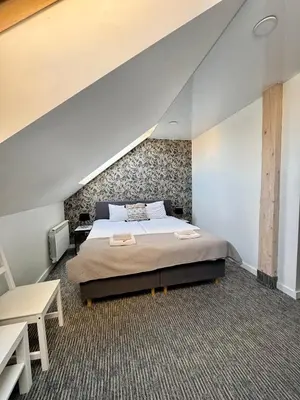 a bedroom with a large bed and a staircase at Grey apartments 