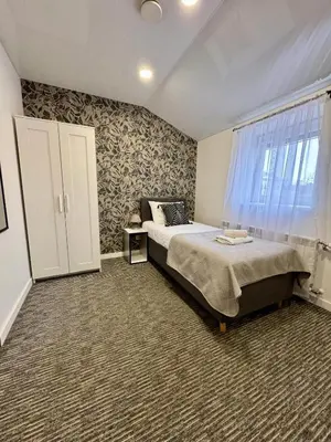 a bedroom with a large bed and a window at Grey apartments 