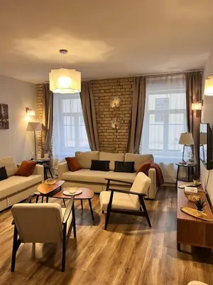 a living room with a couch and tables and chairs at Brand new flat heart of Vilnius in Vilnius
