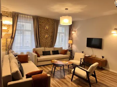a living room with a couch and a tv at Brand new flat heart of Vilnius in Vilnius
