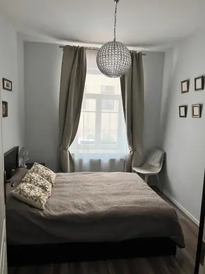 a bedroom with a large bed and a window at Brand new flat heart of Vilnius in Vilnius