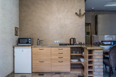 a kitchen with a white refrigerator and a counter at Remigija Studio Home in Jonava