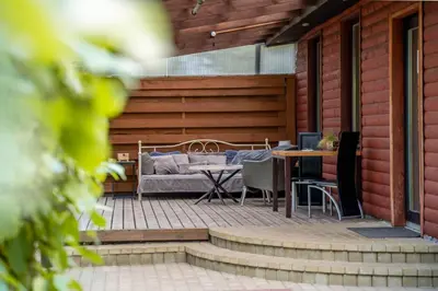 a patio with a bed and a table and chairs at Remigija Studio Home in Jonava