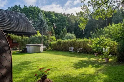a yard with two chairs and a gazebo at Remigija Studio Home in Jonava