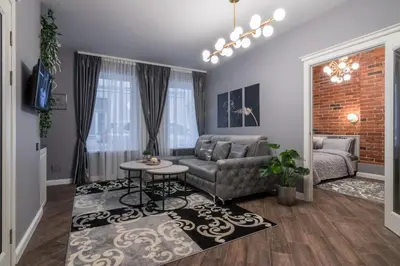 a living room with a couch and a table at Dandelion apartment in the heart of Kaunas in Kaunas