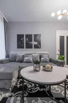 a living room with a couch and a table at Dandelion apartment in the heart of Kaunas in Kaunas