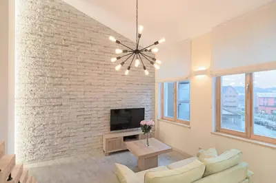 a living room with a brick wall at Kaunas City Center loft by URBAN RENT in Kaunas