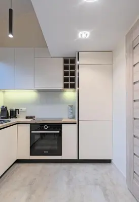 a kitchen with white cabinets and a refrigerator at Kaunas City Center loft by URBAN RENT in Kaunas