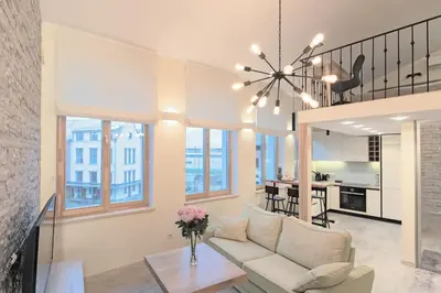 a living room with a couch and a table at Kaunas City Center loft by URBAN RENT in Kaunas