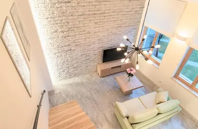 an overhead view of a living room with a brick wall at Kaunas City Center loft by URBAN RENT in Kaunas