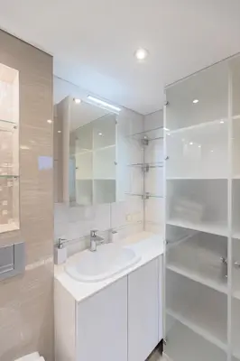 a white bathroom with a sink and a mirror at Kaunas City Center loft by URBAN RENT in Kaunas