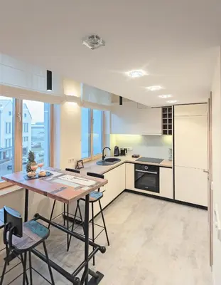 a kitchen with a table and some chairs in it at Kaunas City Center loft by URBAN RENT in Kaunas
