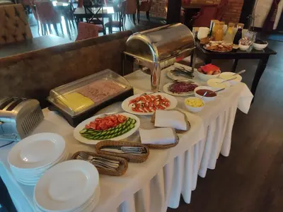 a table with plates of food on top at Dzūkijos dvaro 