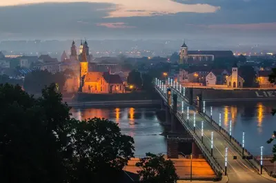a view of a river with a bridge and a city at Green Hill Apartments in Kaunas