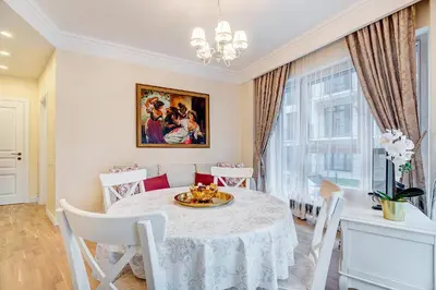 a dining room with a white table and chairs at HaPPy Inn Classical style, self check-in, Parking in the underground garage in Vilnius
