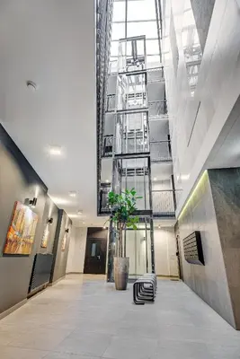 a hallway with a plant in the middle of a building at HaPPy Inn Classical style, self check-in, Parking in the underground garage in Vilnius