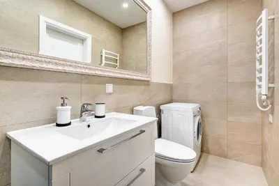 a bathroom with a toilet and a sink and a mirror at HaPPy Inn Classical style, self check-in, Parking in the underground garage in Vilnius