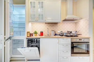 a kitchen with white cabinets and a dishwasher at HaPPy Inn Classical style, self check-in, Parking in the underground garage in Vilnius