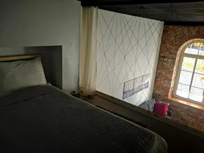 a bedroom with a bed and a window at Botanical Garden Studio in Kaunas