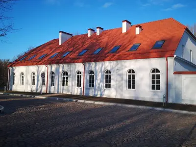 a large white building with a red roof at Botanical Garden Studio in Kaunas