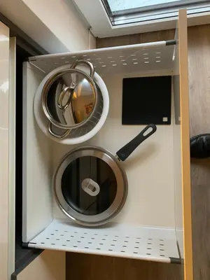 a microwave with two frying pans in a box at Near Ozas Studio in Vilnius