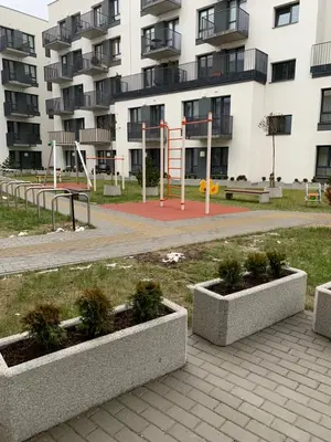 a park with two concrete planters in front of a building at Near Ozas Studio in Vilnius