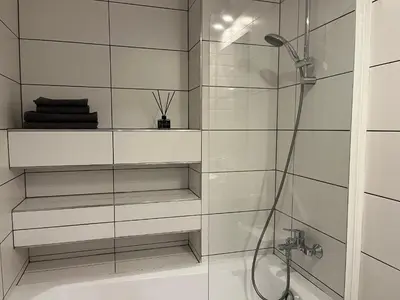 a bathroom with a shower with a glass wall at Near Ozas Studio in Vilnius