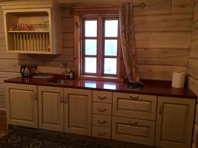 a kitchen with a counter and a window at Baublys Lake Lodge in Viktarinas