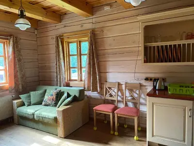 a living room with a couch and two chairs at Baublys Lake Lodge in Viktarinas