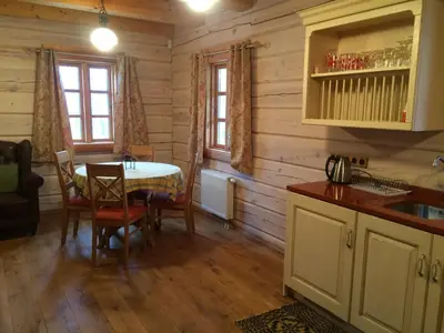 a kitchen with a table and a dining room at Baublys Lake Lodge in Viktarinas