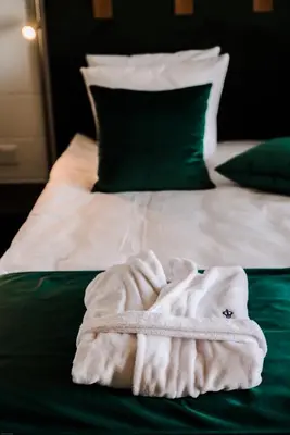a white towel sitting on top of a bed at Ego SPA - Adults Only in Birštonas
