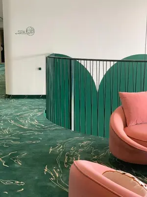 a room with a green floor and a pink chair at Ego SPA - Adults Only in Birštonas