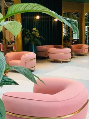 a waiting room with pink chairs and plants at Ego SPA - Adults Only in Birštonas