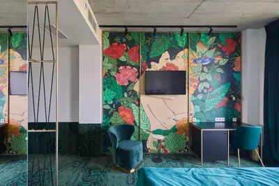 a bedroom with a wall with a mural of flowers at Ego SPA - Adults Only in Birštonas