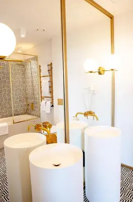 a bathroom with three sinks and a mirror at Ego SPA - Adults Only in Birštonas