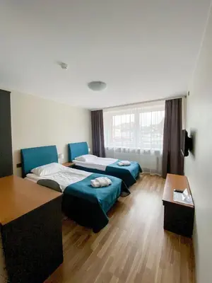 a hotel room with two beds and a table at 